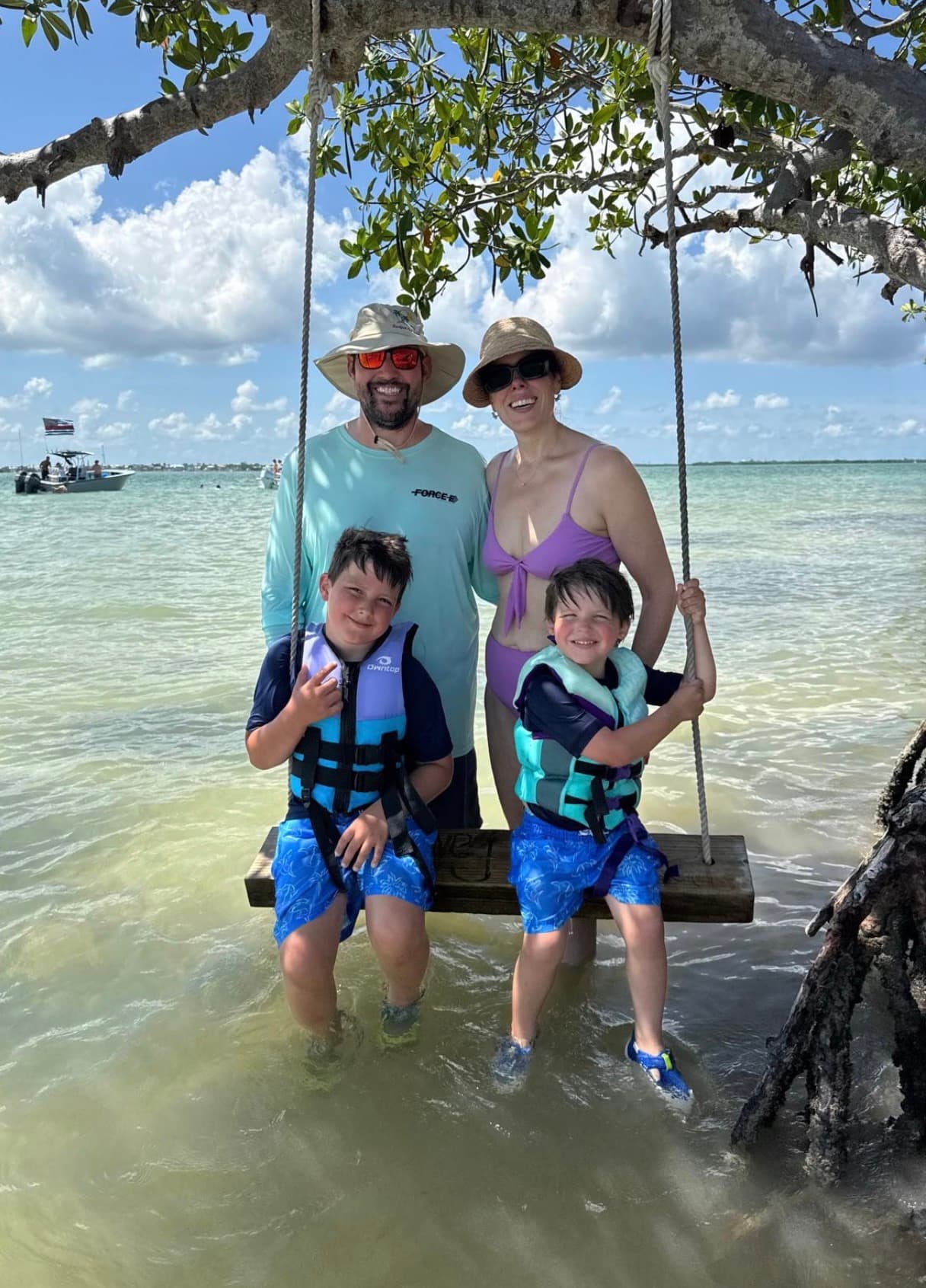 Kelsey and Todd with their two boys on the water
